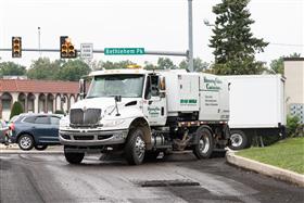 Blooming Glen Contractors: A International broom truck cleans up excess milling debris from the freshly milled roadway.